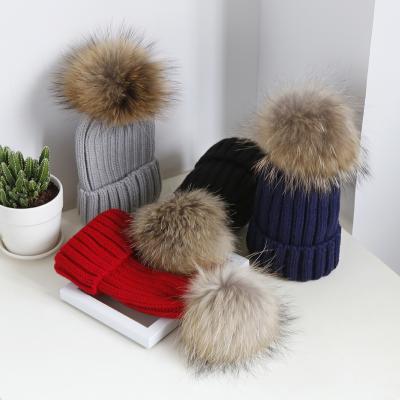 China Women's Custom Raccoon Fur Ball Pom Pom Hat Knitted Beanie Hat New Style Medium Warm Winter Big Real Knit Hat for sale