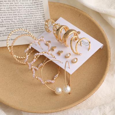 China CLASSIC creative personality punk stud earring for women twist big pearl circle earring set for sale