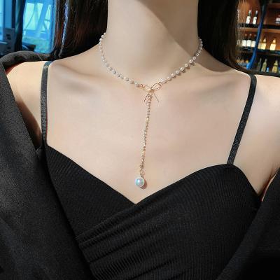 China Vintage Fashion Jewelry Pearl The New Pearl Necklace For Women Shining Stone Butterfly Knot Pendant Necklace for sale