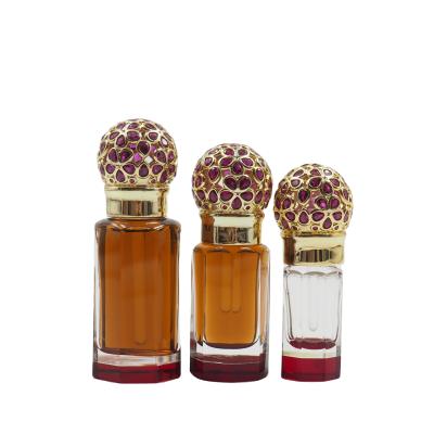 China Hot Sale Luxury 3ml 6ml 12ml Crystal Base Fancy Attar Tola Personal Care Red Bottle With Jewelry Cap For Oud Oil for sale