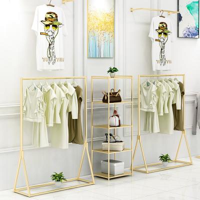 China Beautiful Metal Boutique Gold Clothing Store Display Stand Retail Rack For Clothing Store for sale