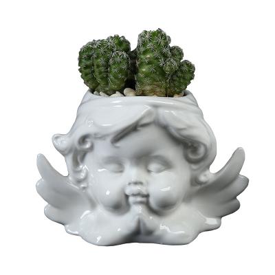 China CLASSIC creative gardening desktop ceramic pot belt flower pot character angel flower pot succulent desktop for sale