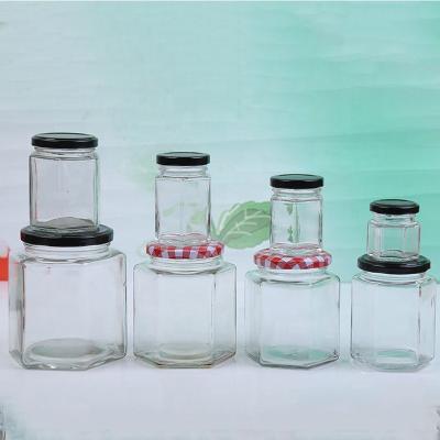 China Sustainable Different Size Hexagon Glass Honey Jar With Metal Lid For Storage for sale