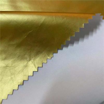 China 100% Polyester Gold Foiled Winter Breaker Fabric 50D*50D 100gsm 150cm Waterproof for sale