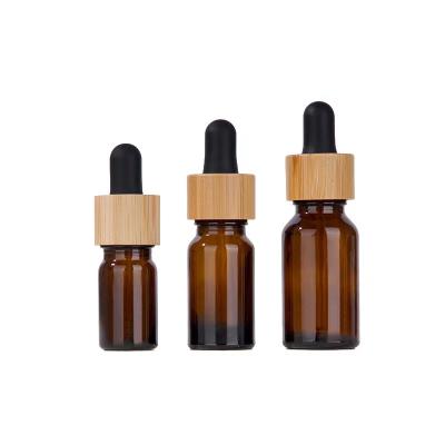 China High Quality 5ml 10ml 15ml 30ml 50ml 100ml Cosmetic Packaging Bamboo Frosted Amber Green Blue Clear Glass Essential Oil Dropper Bottles for sale