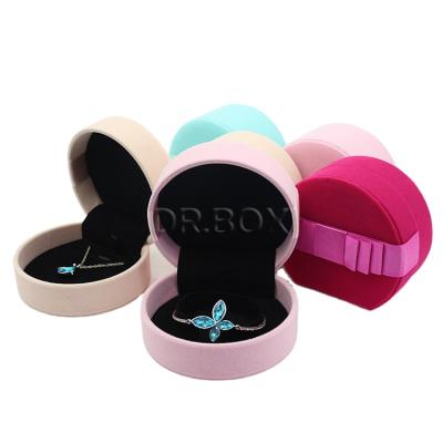 China Customized Round Jewelry Box Fine Hand Made Velvet Jewelry Packaging Box Plastic Jewelry Box With Ribbon Bow for sale