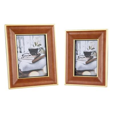 China Custom Light Luxury Orange Leather Model Room Metal Picture Frame Wind Bedroom Desk 7 Inch Brass Picture Stand for sale