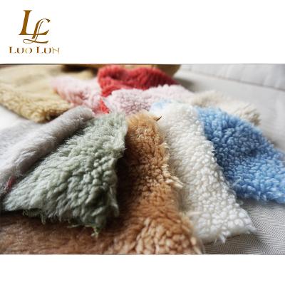 China Fashionable Cream Auto Upholstery Granule Lamb Faux Fur Fabrics Plush Fabric Small Large For Wool Coat Garment for sale