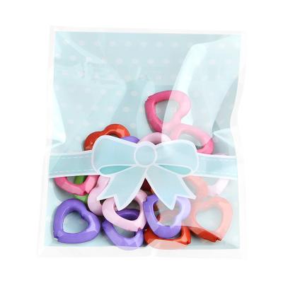 China Self Adhesive Opp Seal Candy Bag Wholesale Self Adhesive Cookie Bowknot Seal Candy Bag For Food Packaging 8x10+3cm 100/Pack for sale