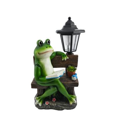 China Europe Custom Wholesale Resin Cute Frog Reading Book Crafts Lovely Garden Solar LED Lights Ornament Statue for sale