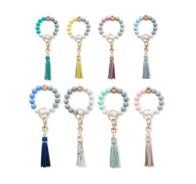 China 2021 Gift Elastic Keychain Silicone Bead Bracelet Key Chain Wood Beads Leather Keychain Tassel Key Chain Bracelet Bangle For Women for sale