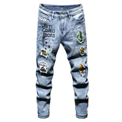 China Breathable printed ripped European jeans men and American ink brand youth splattered slim stretch pants for sale