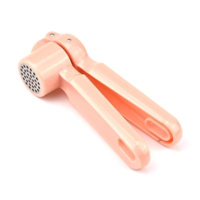 China Viable Kitchen Tool Accessories Pink Color Zinc Alloy Garlic Press With Soft Handle for sale