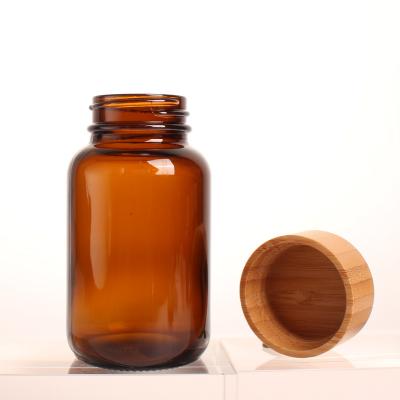 China Eco-friendly Amber Color Glass Bottle 120cc Bamboo Lid Capsule Pill Tablet Storage Bottle For Medicine Pill Capsule Bottle Storage for sale