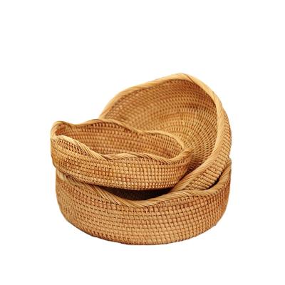 China New viable wave-shaped rattan basket home coffee table fruit storage basket rattan decoration for sale