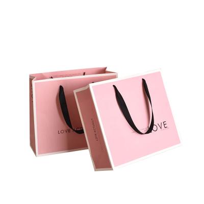 China Recycled Materials Wholesale Custom Printed Black Luxury Shopping Paper Gift Bag With Handle for sale