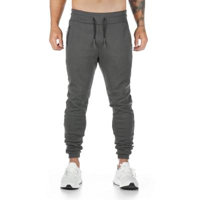 China Anti-Wrinkle Solid Color OEM Logo Pockets Sweatpants Joggers Slim Fitness Pants Men Casual Cargo Track Pants Long for sale