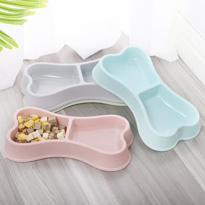 China Viable Wholesale ABS Bone Shape Plastic Dog Cat Pets Food Water Double Dog Wheels Conductive for sale