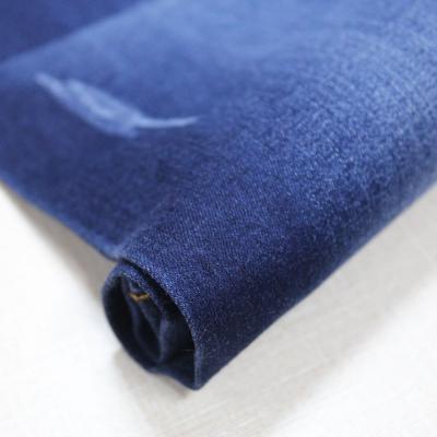 China Low Price Breathable Stretch Yarn-dyed Wholesale Sand Wash Light Weight Denim Fabric Jeans Large Stock For Clothing Luggage for sale