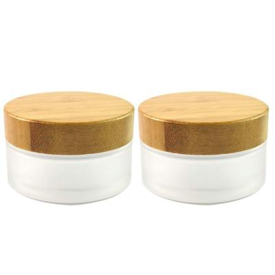 China Hot Selling Cosmetic Frosted Flint Glass Cream Glass Jar Cosmetic Glass Jar With Bamboo Lid for sale