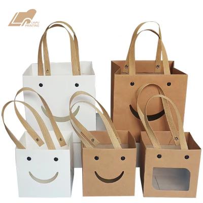 China Materials Kraft Paper Square Bottom Face Bag Card Rivet Rope Recycled Smile White Handbag for sale