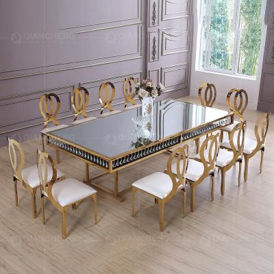 China STABLE new gold dining table showcasing gold velvet set and mirror stainless steel chair for sale