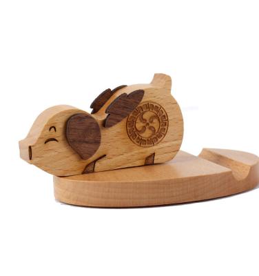 China Waterproof hot sale small pig shape wooden cell phone holder lazy bracket for sale