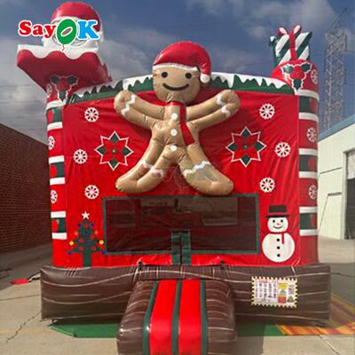 China Free 3d Design 0.55mm PVC Tarpaulin Christmas Inflatable Bouncing Castle Gingerbread Bounce House with Blower for sale