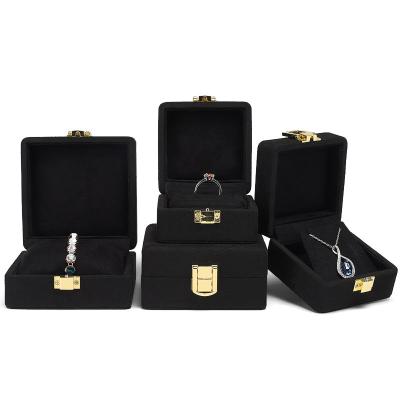 China Plastic popular black flocking box with gold metal lock microfiber jewelry box custom ring and velvet pendant jewelry box for sale