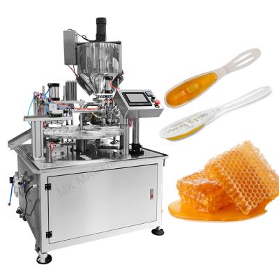 China Food Customized Full Automatic Rotary Honey Spoon Fill Seal Packaging Machine for sale