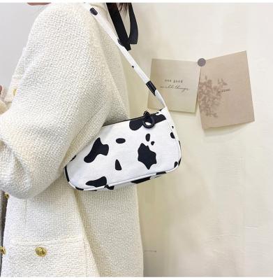 China 2022 fashion wholesale cute cow pattern canvas wrist lady bags shape casual armpit bag for sale