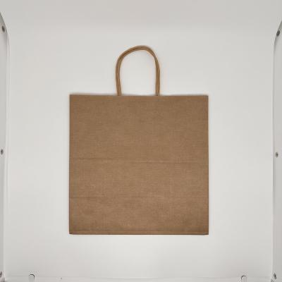 China Handmade Die Cut Handle Kraft Paper Shopping Bag Printed With Logos Brown Craft Paper Shopping Bag for sale