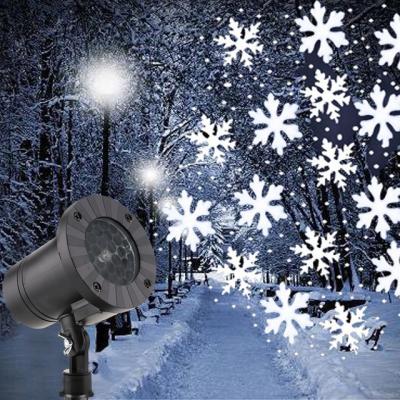 China Christmas Snowflake Laser Light Snowfall Projector IP65 Indoor and Outdoor Moving Snow Garden Lamp for sale