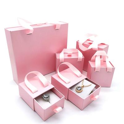 China Receive a Case Luxury Custom Logo Bronzing Pink Packaging Cash Drawer Box Ear Stud Necklace Ring Gift Box Organizer for sale