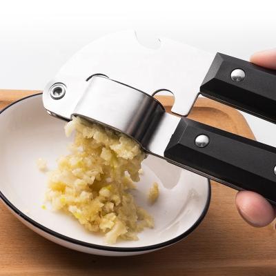 China Viable Kitchen Garlic Press Manual Bottle Opener 2 in 1Mincer Ginger Crusher Squeezer Stainless Steel Garlic Presser Cleaver for sale