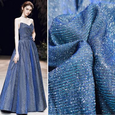 China Cheap Fancy Glitter Fluorescent Fabric 100% Polyester Fancy Shiny Knit Fabric For Formal Wedding Dresses for sale