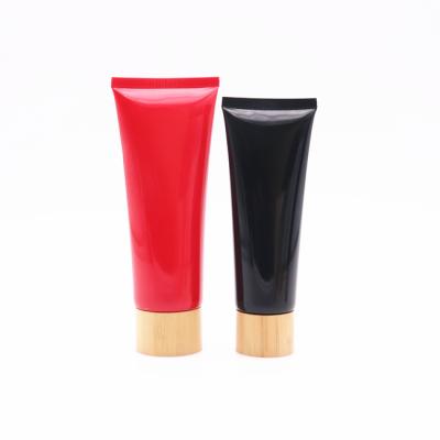 China Hot Sale Cosmetic Black Empty Plastic Squeeze Tube 100g Plastic Tube 60g Red Plastic Tubes With Bamboo Lid for sale