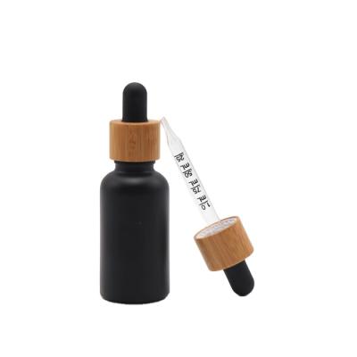 China 30ml Cosmetic Eco-Friendly Bamboo Matte Black Frosted Glass Bottle Essential Oil Dropper Serum Dropper Bottle for sale