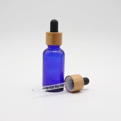 China 1oz Cap 1oz Cosmetic Oil Serum Bottle 10ml 30ml Bamboo Blue Essential Glass Bottle With Scale Dropper Cap for sale