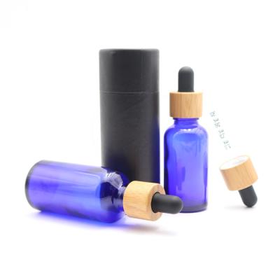 China Wholesale Cosmetic Blue Color Oil Serum Bottle 10ml 30ml Essential Glass Dropper Bottle With Kraft Paper Tube for sale