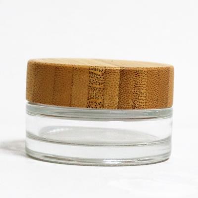 China Cosmetic luxury empty glass cosmetic jar frosted glass jar skin care cream glass jar with bamboo lid for sale