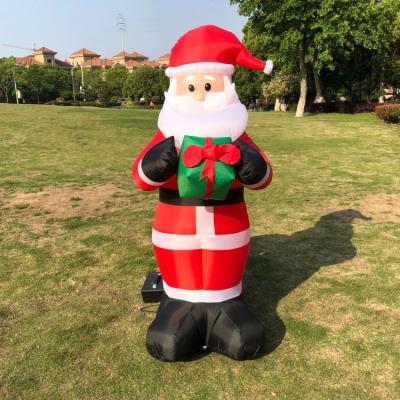 China 100%Polyester Santa With Handbags Gift Welcome Dress Outdoor Christmas Inflatable Decorations for sale