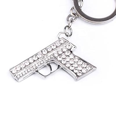 China Hot Selling Zinc Alloy Crystal Rhinestone Mini Gun Model Weapon Keychains Key Chain Fashion Weapon For Car Keys for sale