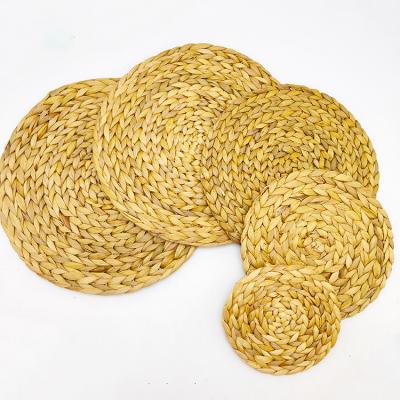 China Sustainable Handwoven Straw Place Mats Squash Grass Place Mats Non-Slip Heat Insulation Pads Coasters for sale