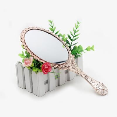 China Convenient Beautiful Design And Decorative Frame Hand Held Makeup Mirror for sale