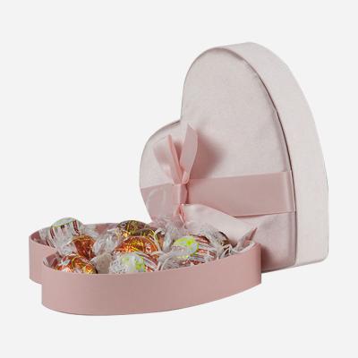 China Recycled Materials Heart Shaped Wedding Satin Chocolate Candy Box In Custom Fabric Pink With Shredded Paper for sale