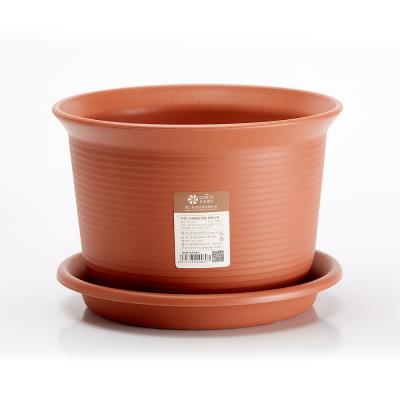 China Wholesale Eco-friendly Cheap Flower Resin Planter Pots Orange With Saucer for sale