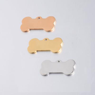 China CLASSIC Pet Accessories 16*31mm Stainless Steel Gold Paw Print Pendant Pet Dog ID Bone Shape Glowing Pendant Charms for sale