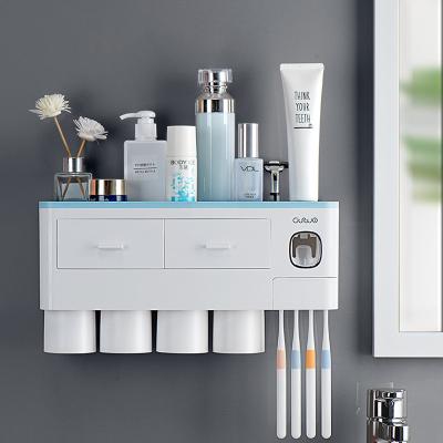 China Viable Creative Automatic Toothpaste Squeezing Bathroom Toothpaste Dispenser Toothbrush Holder Storage Shelf for sale