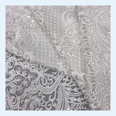 China Viable Wholesale Sparkle Sequins Lace Fabric For Bridal Gowns Wedding Dress White Beaded Lace for sale